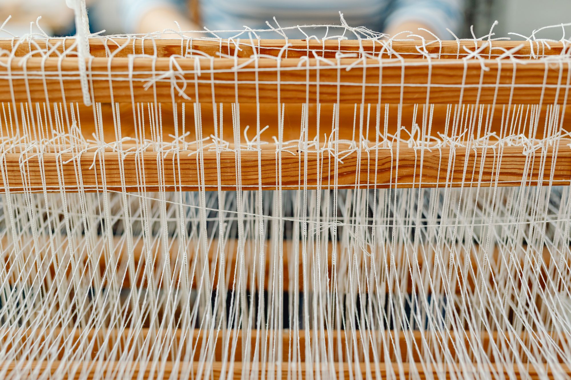 Craftsman weaving saree fabric on a traditional loom